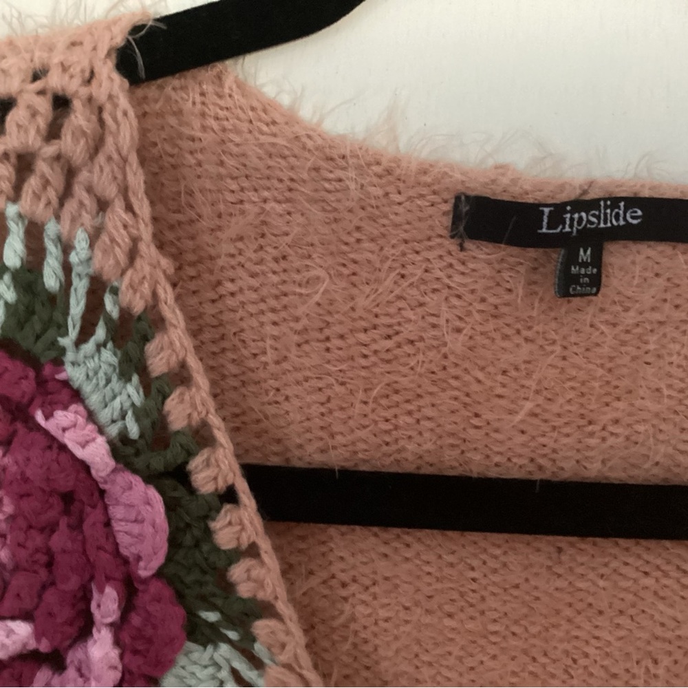 Fluffy peach sweater with crochet flower